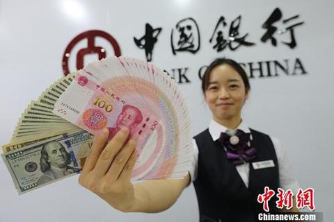 山西太原，银行工作人员展示人民币、美元。<a target='_blank' href='http://www.chinanews.com/'>中新社</a>记者 张云 摄