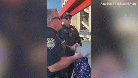 Moment white California cops handcuff a black man for eating a SANDWICH on a train platform_ _ Daily Mail Online1 - 副本.gif